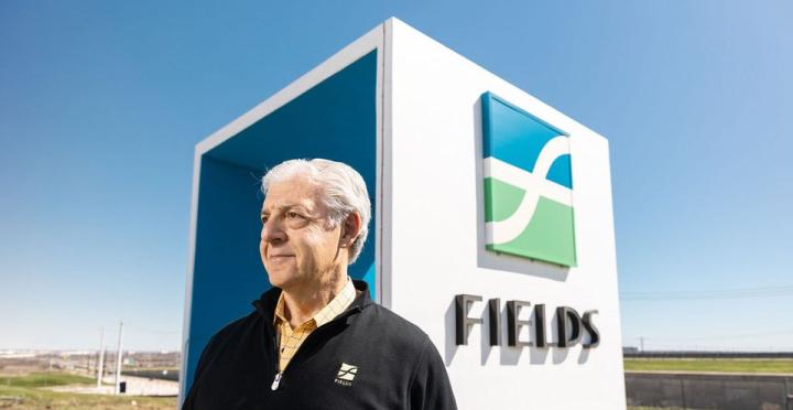 Developer Fehmi Karahan standing in front of the Fields monument sign in Frisco, Texas