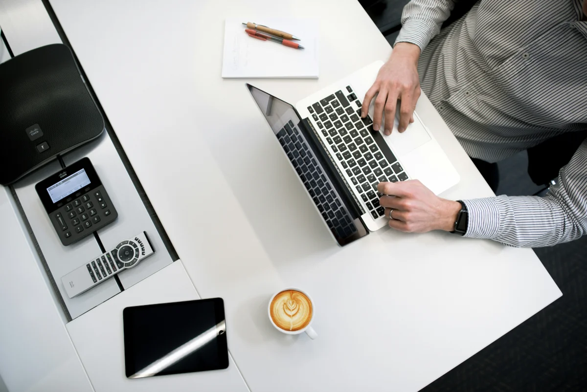 Clerical candidate preparing for an interview with notes, resume copies, and research on the employer