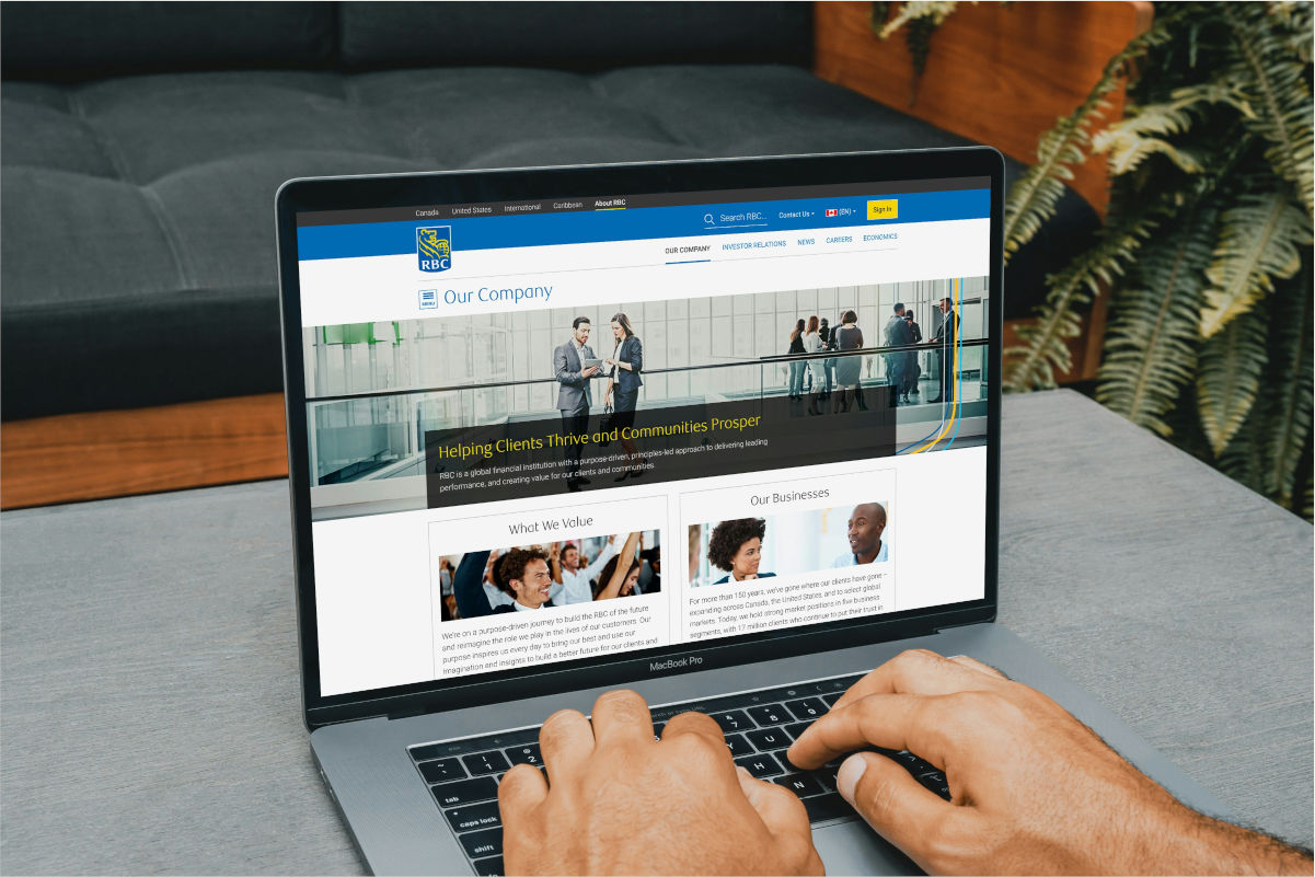 Laptop displaying a staffing agency website homepage with professional headshots and a visible navigation menu, illustrating recruitment agency website design