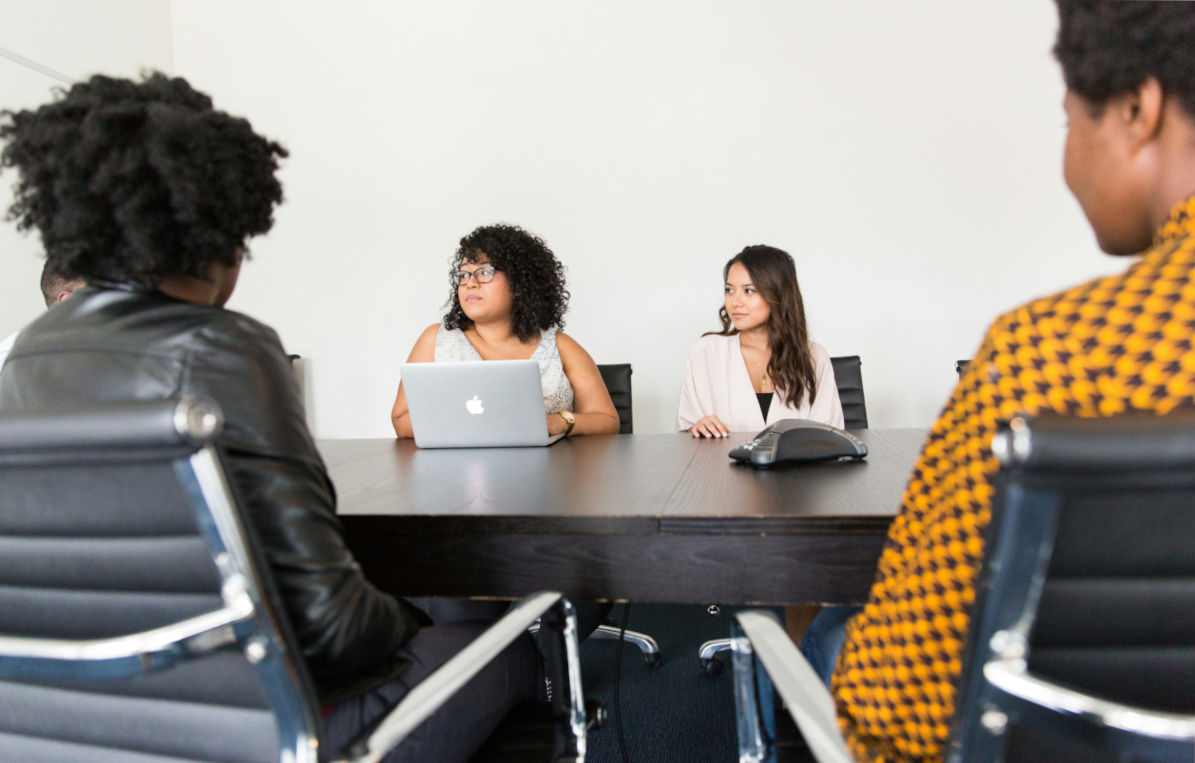 Hiring manager and Frontline Source Group recruiter reviewing 2026 talent acquisition metrics and recruitment KPIs in strategy session