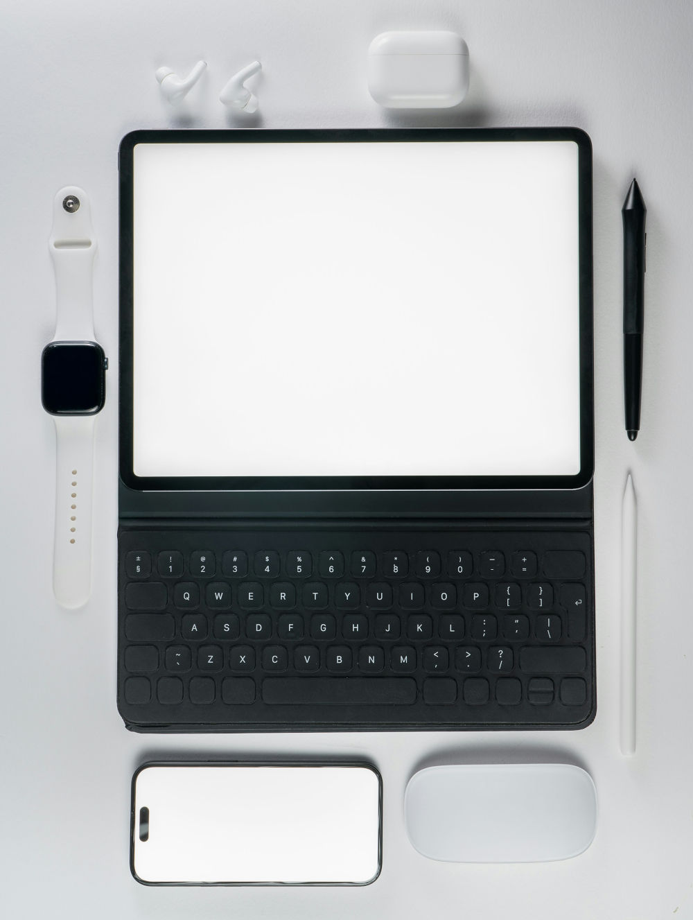 Flat lay of a tablet with keyboard, smartphone, smartwatch, and stylus, illustrating mobile-first recruitment agency website design and testing
